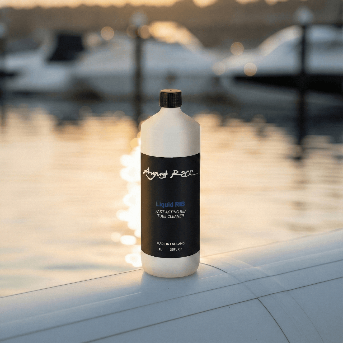 Bottle of August Race liquid RIB cleaner on a rib tube with boats in the background