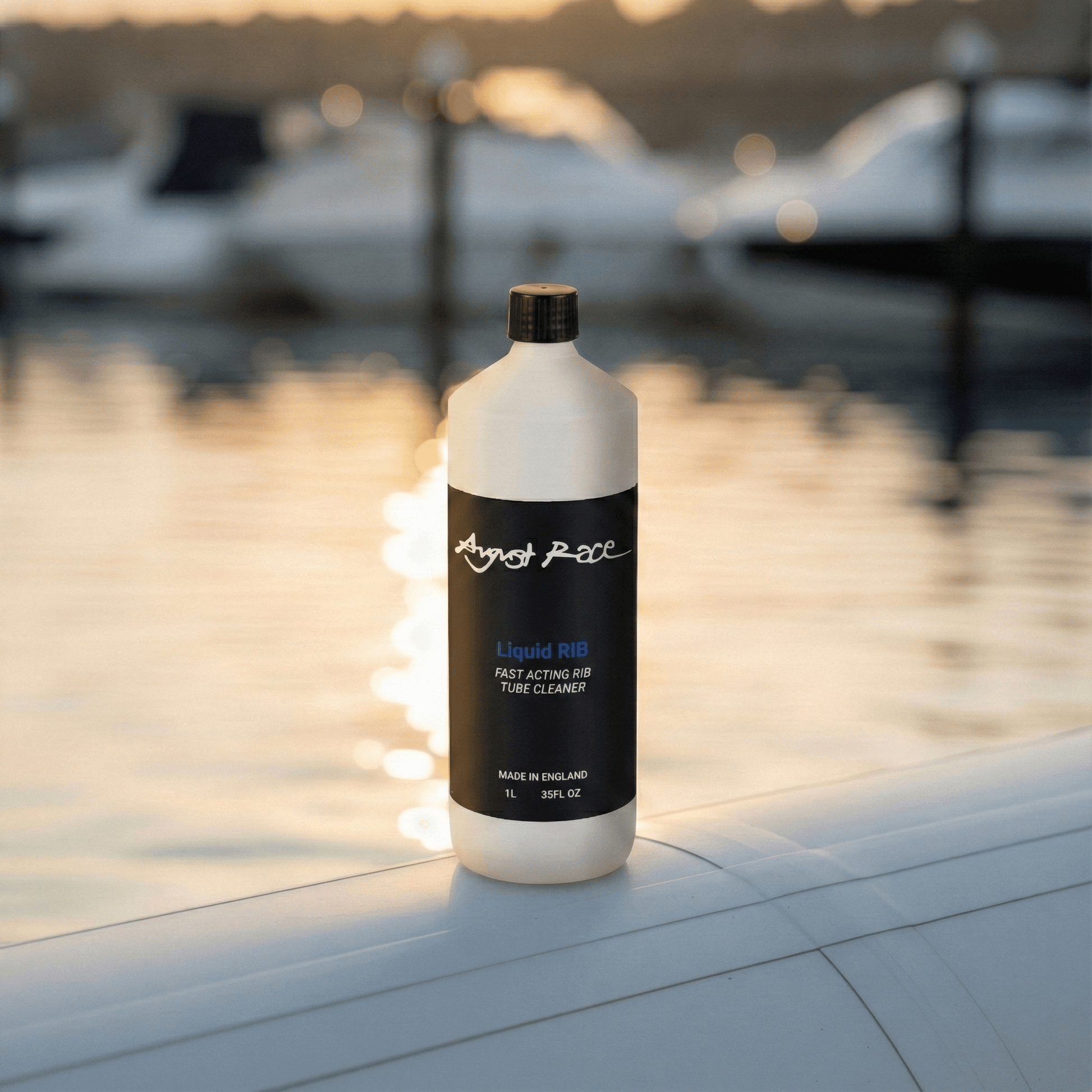 Bottle of August Race liquid RIB cleaner on a rib tube with boats in the background